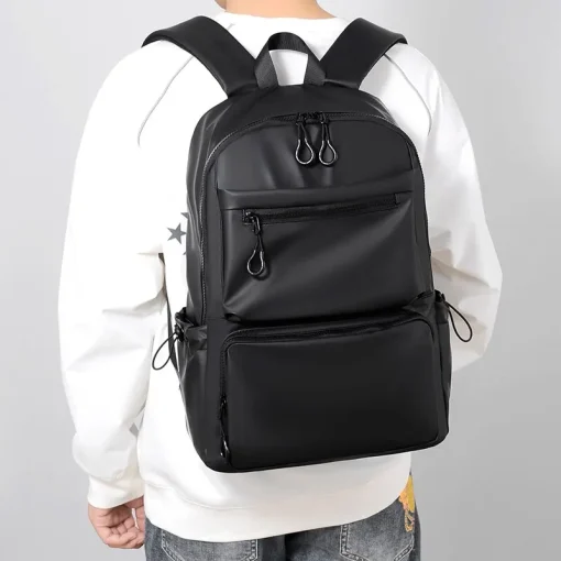 kf S3e474fa884a1405aaef2fa2177859b40n A 14 Inch Men s Backpack Large Capacity Travel Leisure Solid Color Pu Computer Backpack Fashion